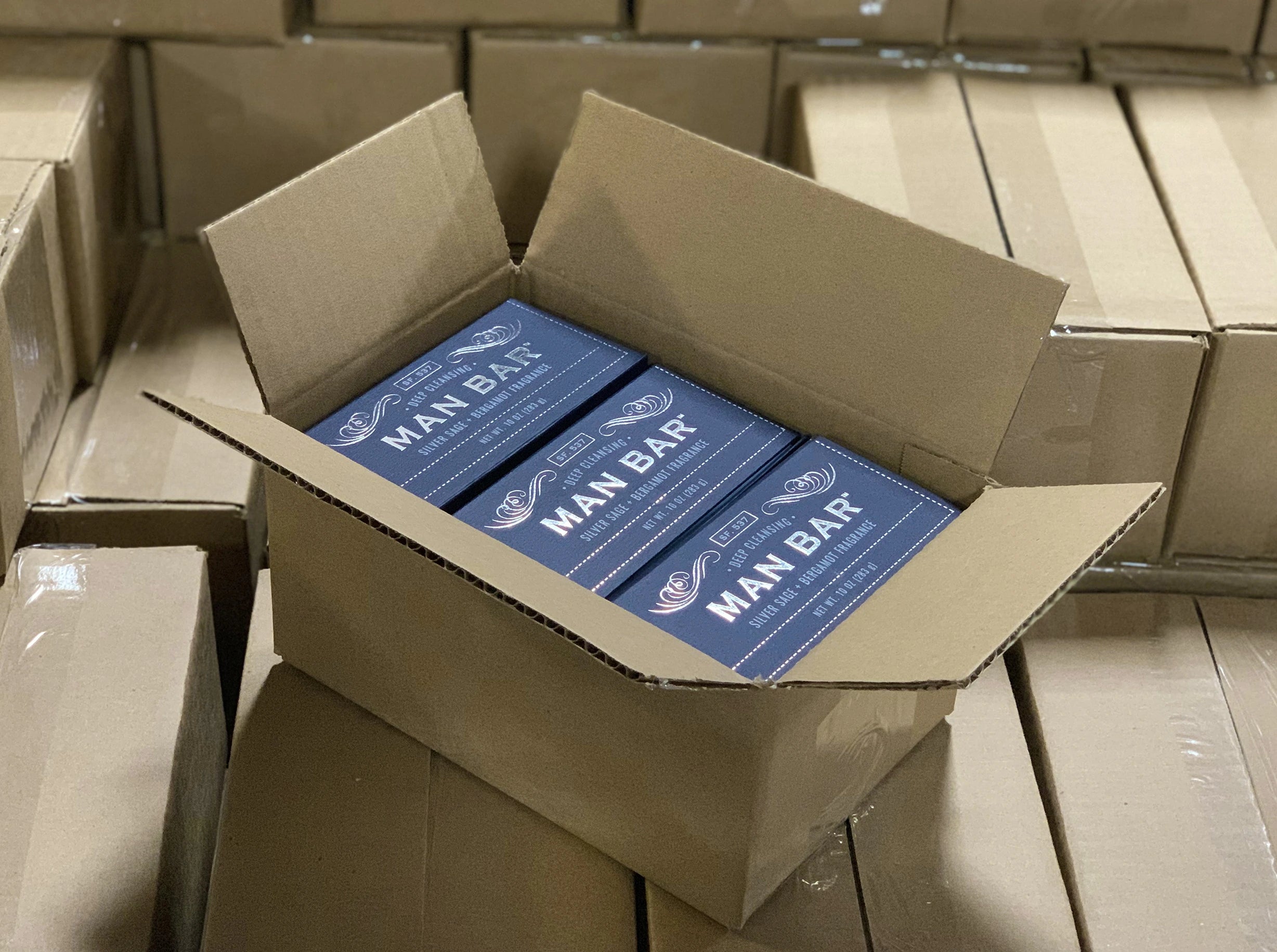 Photo of a pallet of boxes full of Man Bar soaps