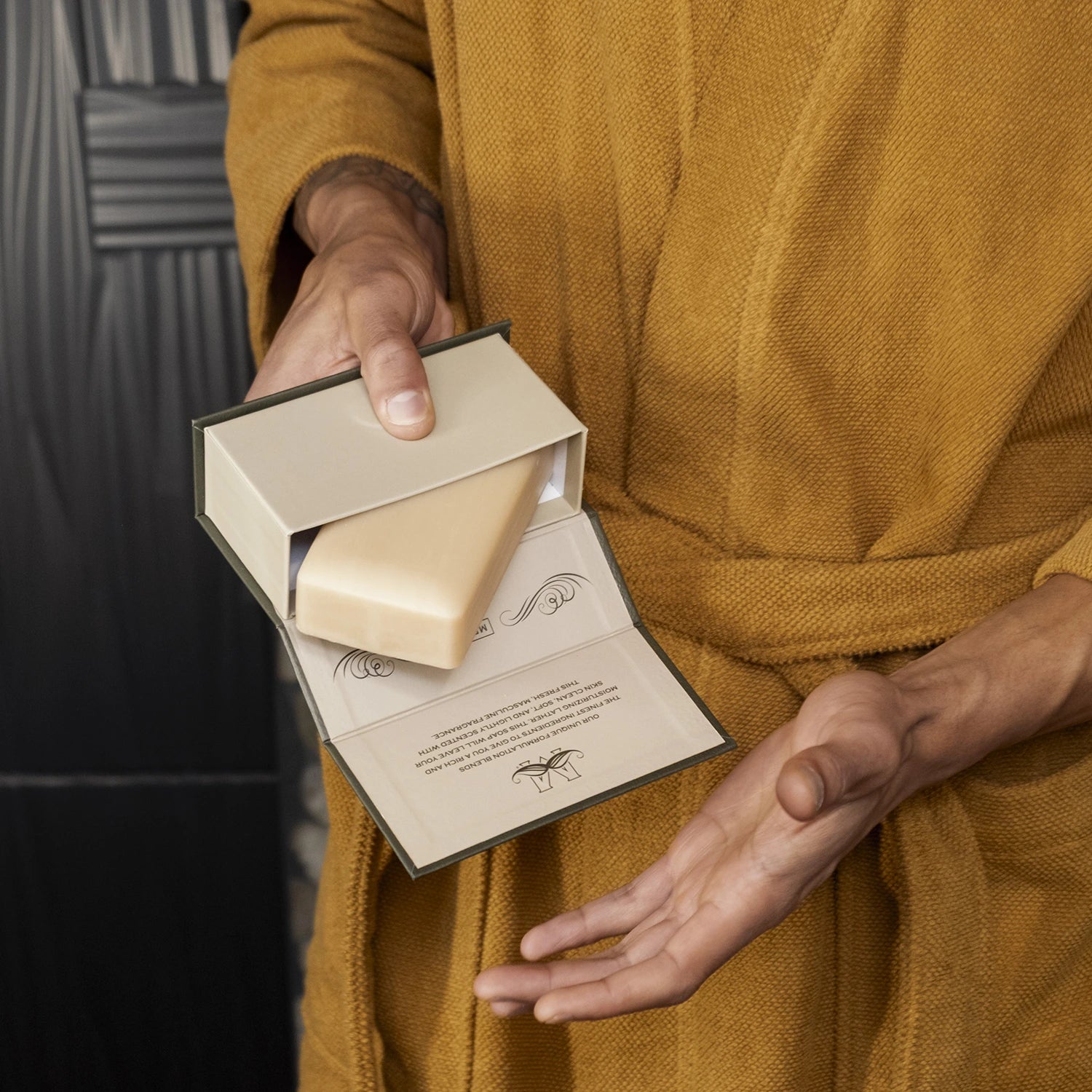 Man's hands holding an open box of Man Bar soap