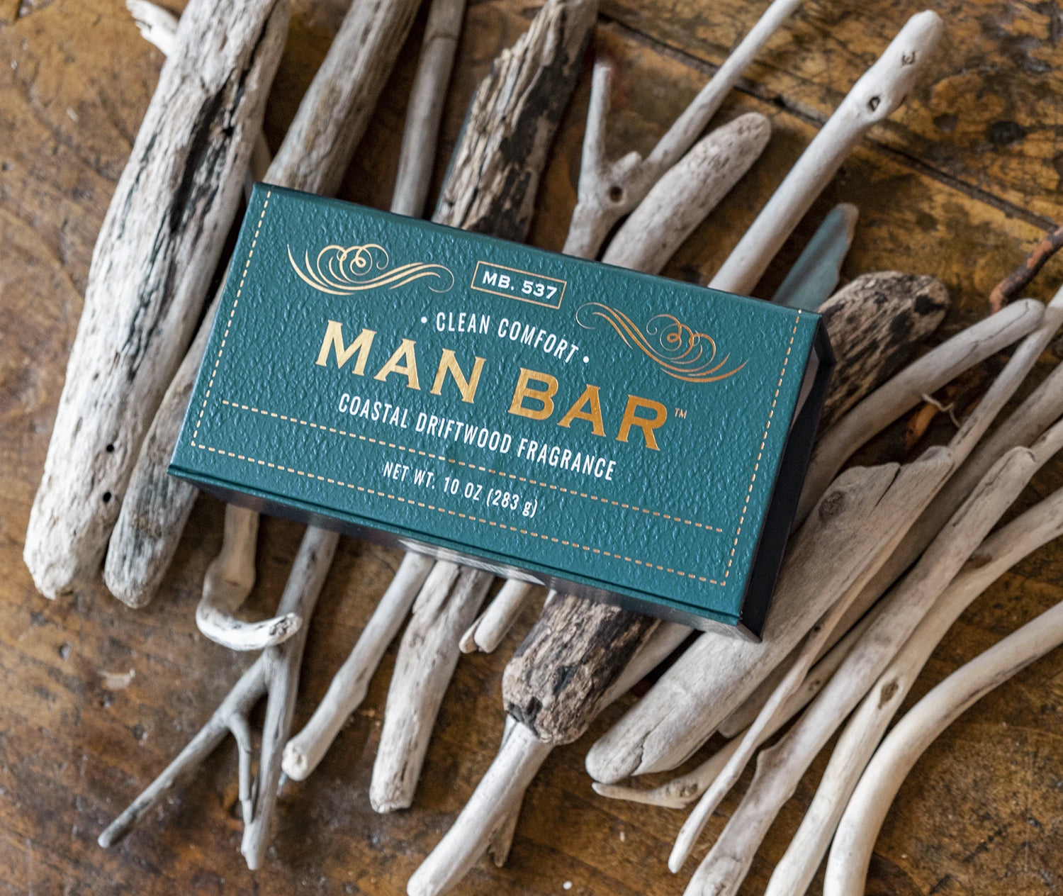 Man Bar Coastal Driftwood soap box sitting on pieces of driftwood