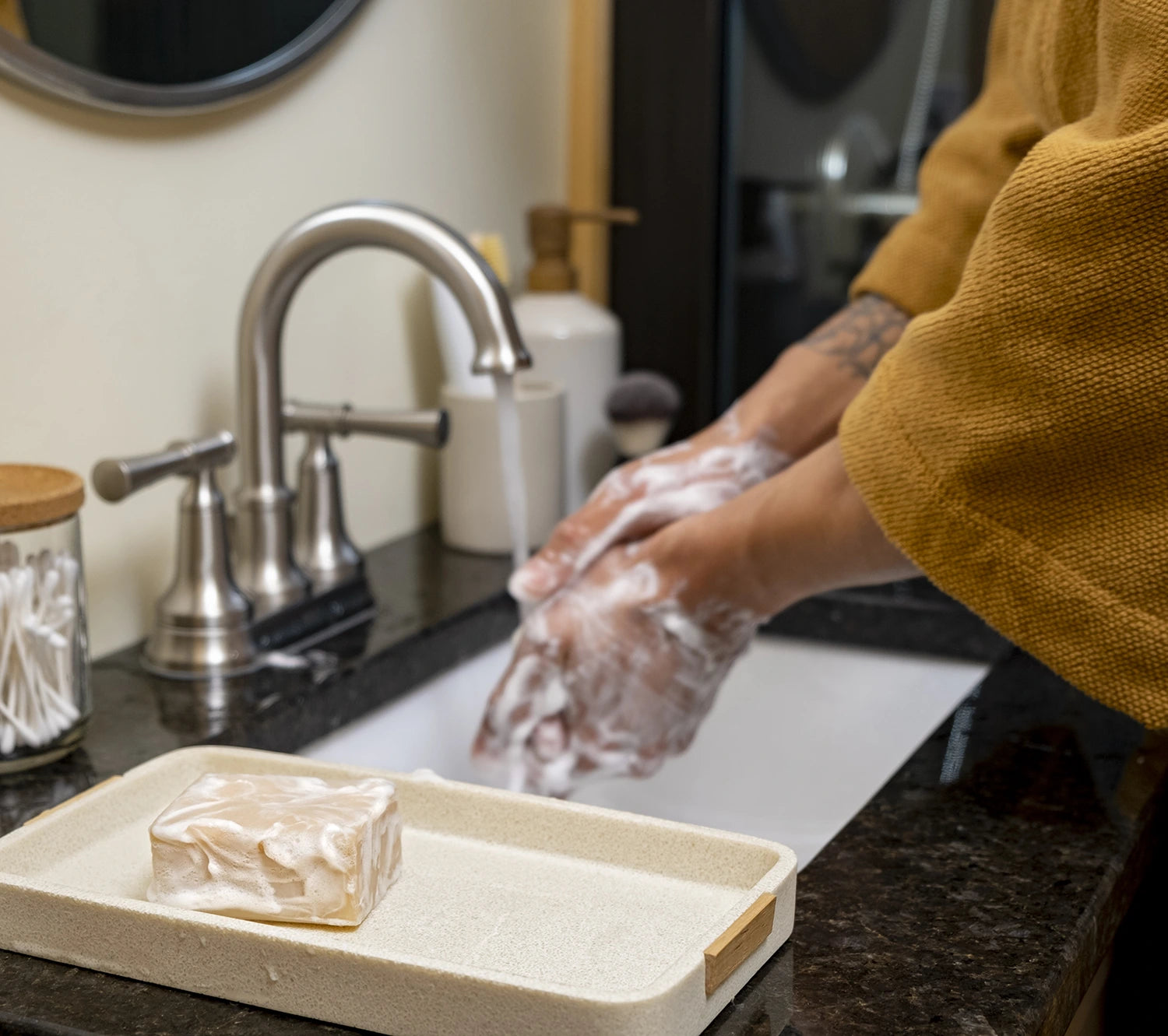 Man's hands lathered up with Man Bar soap at a sink