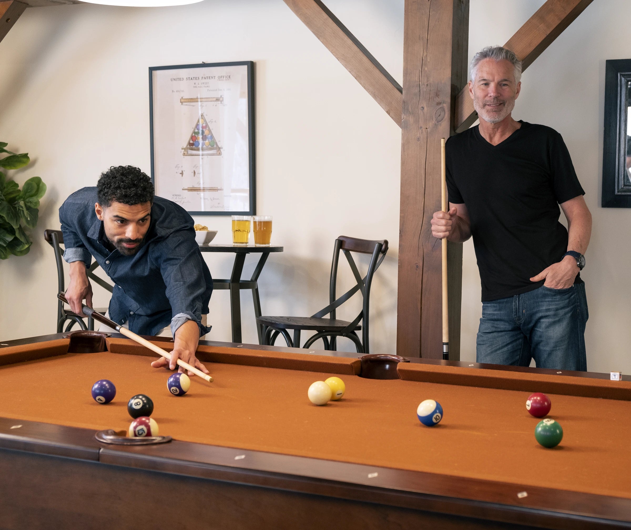 Two male models playing billiards