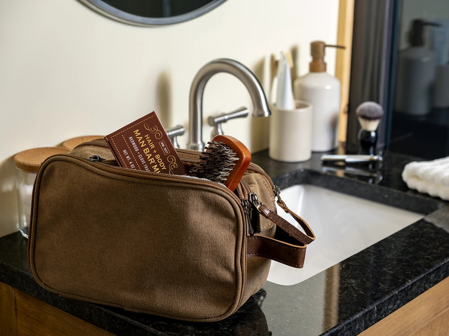 Mens travel toiletries bag with a Man Bar Mini box sticking out