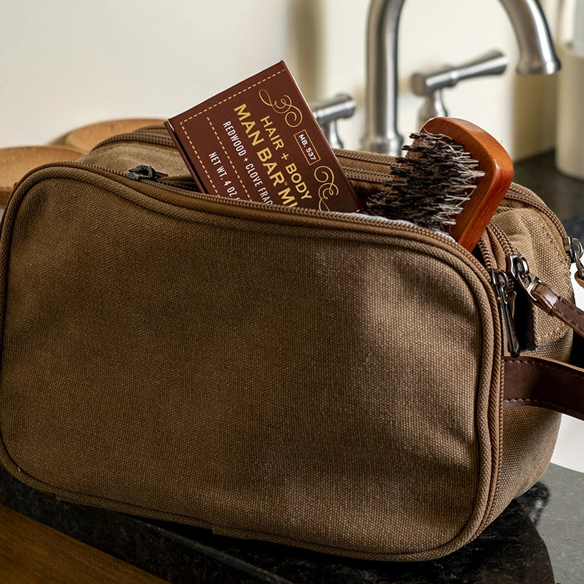 Mens travel toiletries bag with a Man Bar Mini box sticking out